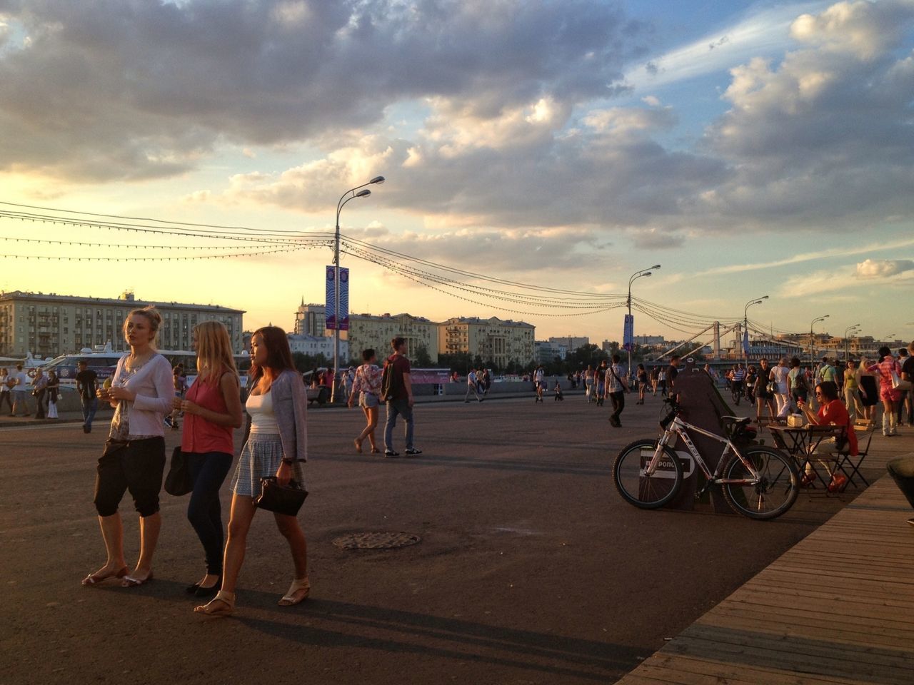 large group of people, men, sky, person, lifestyles, mixed age range, leisure activity, cloud - sky, street, transportation, bicycle, city life, city, walking, architecture, land vehicle, built structure, road, mode of transport