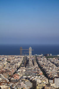 High angle view of buildings in city against clear sky