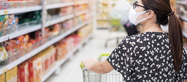 Midsection of woman standing by store