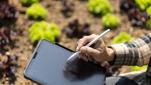 Midsection of man using digital tablet