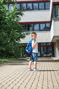 Full length of boy on building