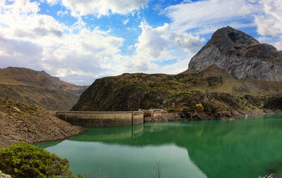 Scenic view of lake and mountains against sky