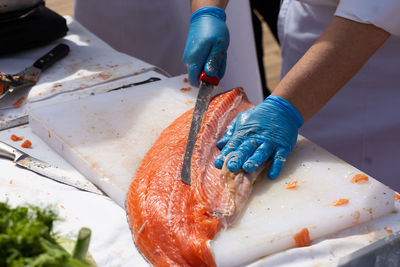 Midsection of person preparing fish