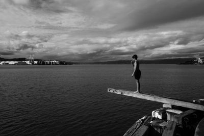 Silhouette of woman against cloudy sky