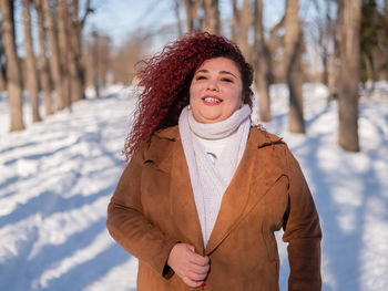 Smiling woman in woods during winter