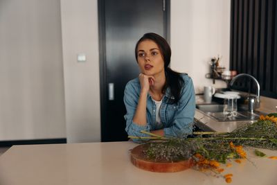 Portrait of young woman sitting at home