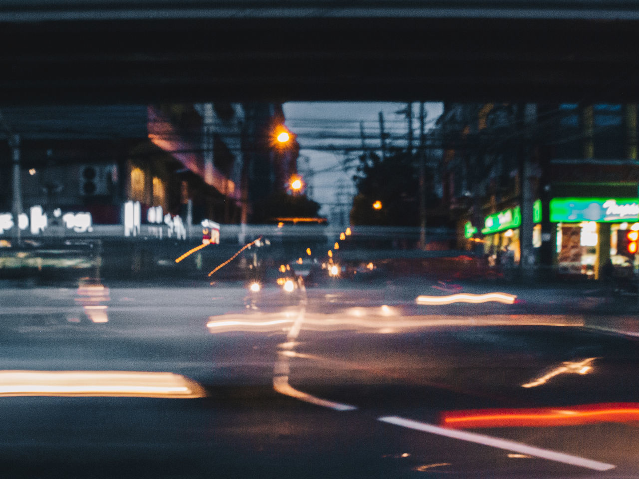 CARS ON ILLUMINATED CITY STREET AT NIGHT