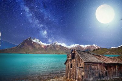 Scenic view of snowcapped mountains against sky at night