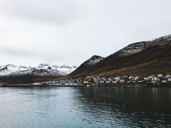 Scenic view of lake and snowcapped mountains against sky