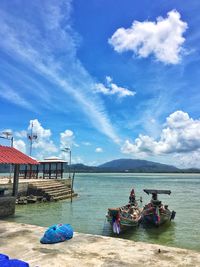 Fishing boat moored at the pier, beautiful cloudy sky, in nakhon si thammarat, thailand.