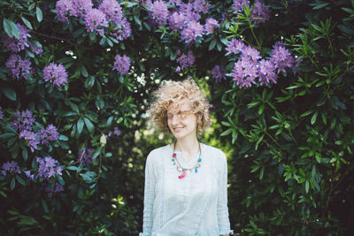 Woman against purple flowering plants