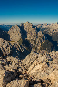 Scenic view of rocky mountains against clear blue sky