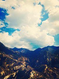 Scenic view of mountains against cloudy sky