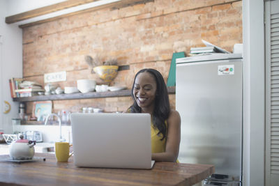 Businesswoman working on her laptop from home