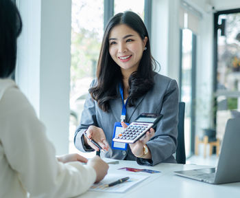 Portrait of female friends working at office