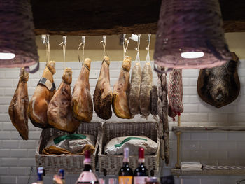 Ham assortment and sausages in italian butcher shop.