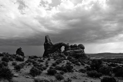 Rock formation on landscape against sky