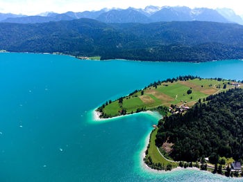 High angle view of sea and mountains against sky