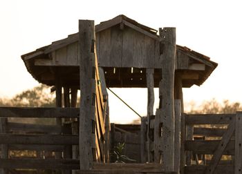Old wooden house on field against sky