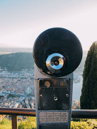 Coin-operated binoculars at observation point against clear sky