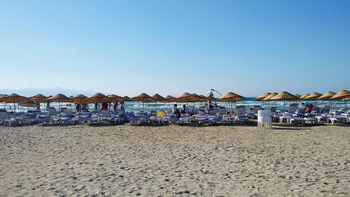 Parasols and lounge chairs on sandy beach