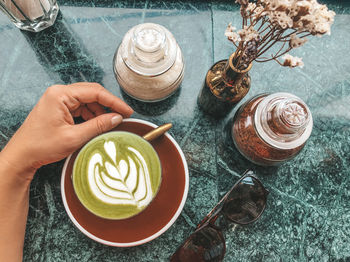 High angle view of matcha latte cup on table