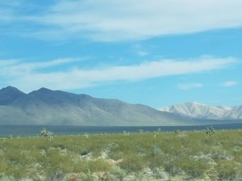 Scenic view of landscape and mountains against sky