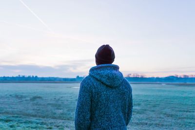 Rear view of woman looking at sea against sky