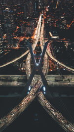 Aerial view of illuminated bridges in city at night