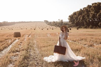 Rear view of woman standing on field