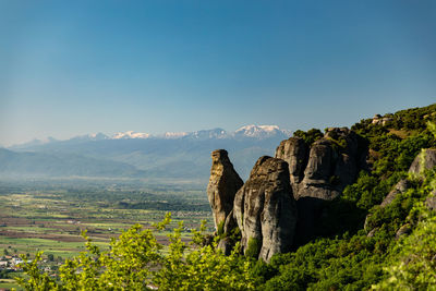 Scenic view of rocky mountains against clear blue sky