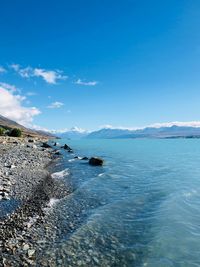 Scenic view of sea against blue sky