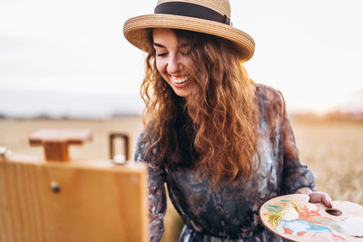 Portrait of smiling young woman in hat