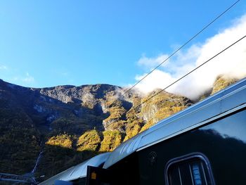 Scenic view of mountains against blue sky