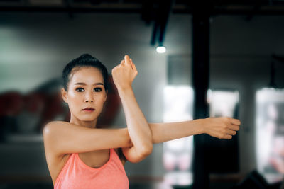 Portrait of young woman standing at home