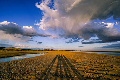 Panoramic view of empty road on field against sky during sunset