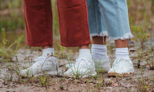 Low section of friends standing on grass