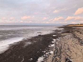 Scenic view of beach against sky during sunset