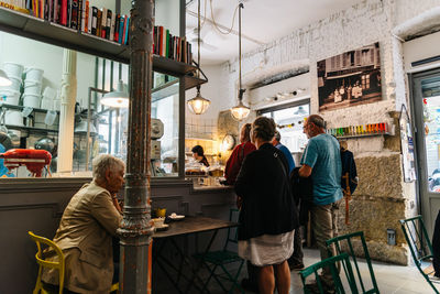 Rear view of people standing on table