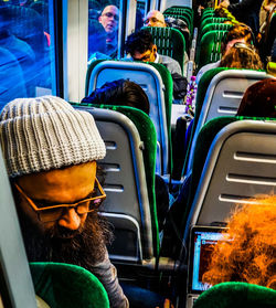 Rear view of woman sitting in bus