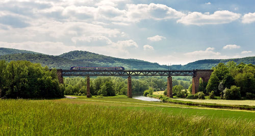 Scenic view of bridge over landscape against sky