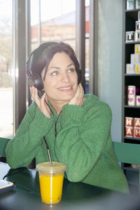 Smiling woman listening music