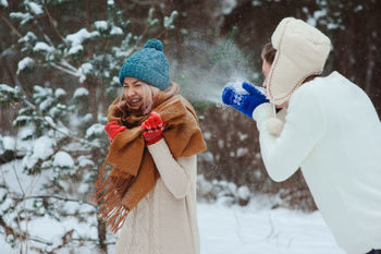 Man and woman enjoying in snow during winter