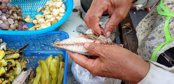 Midsection of man preparing food at street market