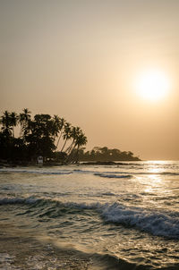 Scenic view of sea against clear sky at sunset