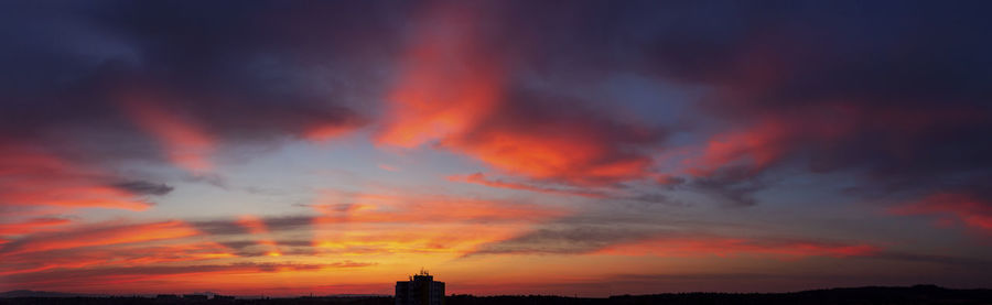 Low angle view of silhouette buildings against sky during sunset