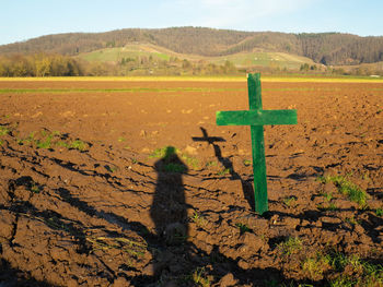 Shadow of cross on land