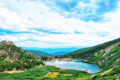 Scenic view of river amidst trees against sky