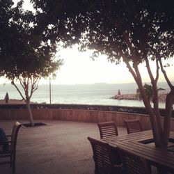 Empty bench by sea