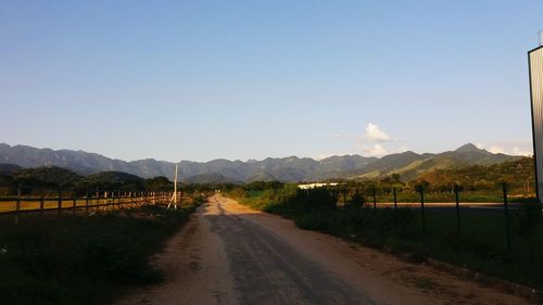 Road amidst landscape against clear sky